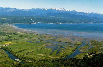 aerial of estuary with mountains in the background